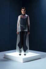 Camisa oversized em organza de seda com botões forrados e segunda pele de tecido de acetato. Transparência sofisticada com conforto e presença.
