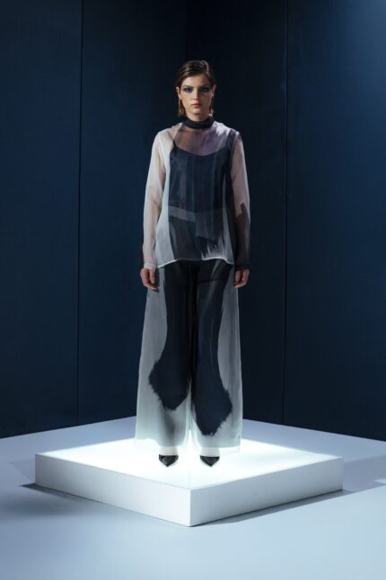 Camisa oversized em organza de seda com botões forrados e segunda pele de tecido de acetato. Transparência sofisticada com conforto e presença.