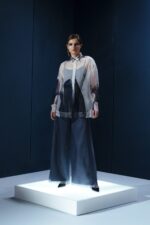 Camisa oversized em organza de seda com botões forrados e segunda pele de tecido de acetato. Transparência sofisticada com conforto e presença.