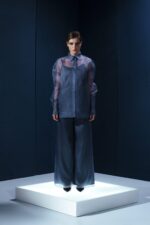 Camisa oversized em organza de seda com botões forrados e segunda pele de tecido de acetato. Transparência sofisticada com conforto e presença.