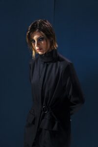 Blazer em lã fria com gola alta e ajuste na cintura com argola metálica. Ideal para invernos leves. Elegância e proteção no mesmo gesto.