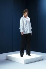 Camisa branca de tricoline com recorte estratégico no cotovelo. Silhueta reta com refinamento contemporâneo e caimento sofisticado.