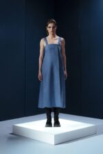 Vestido midi em linho com pregas frontais, alças largas ajustáveis e detalhe estruturado nas costas. Minimalismo com personalidade.