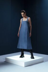 Vestido midi em linho com pregas frontais, alças largas ajustáveis e detalhe estruturado nas costas. Minimalismo com personalidade.